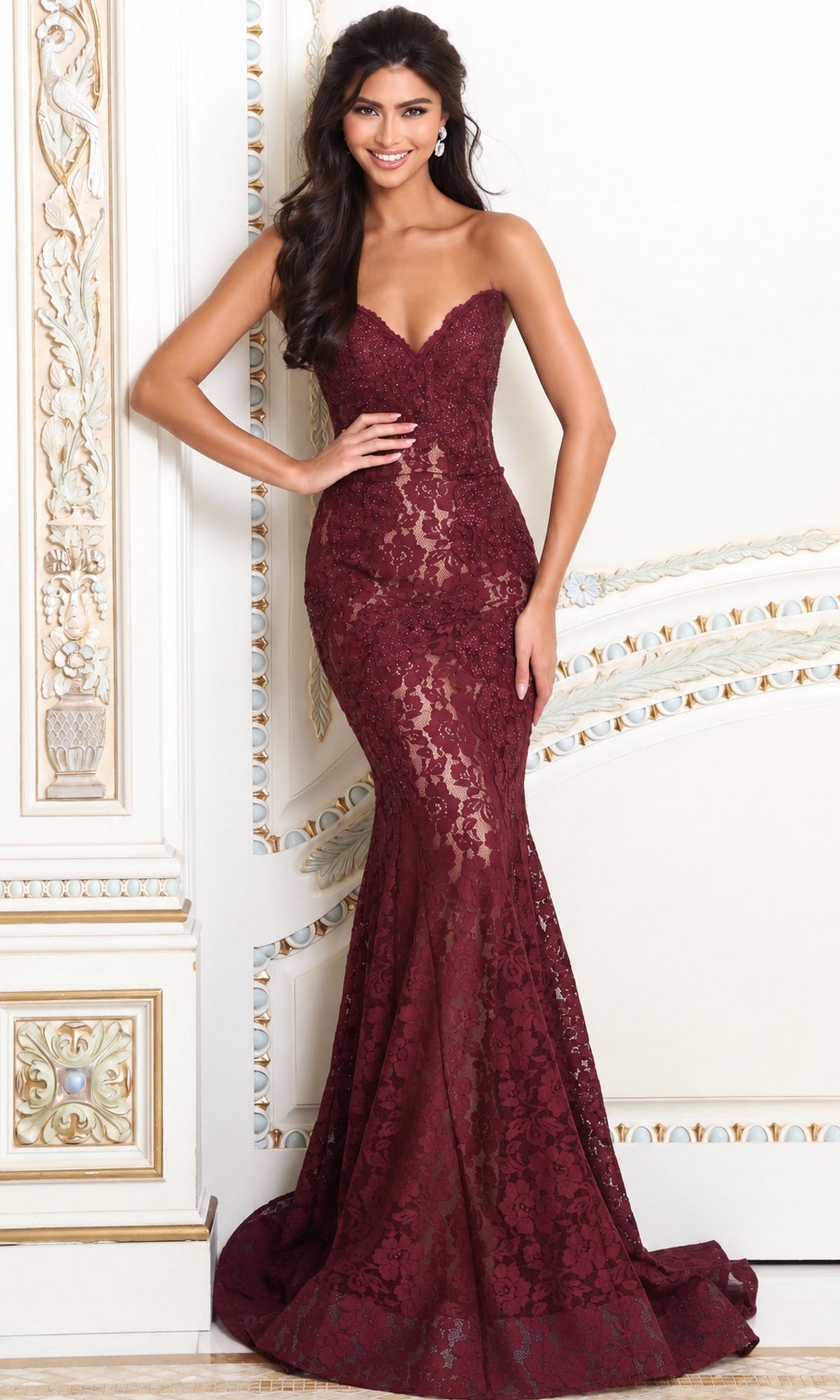 A woman wears a burgundy, floor-length, sweetheart neckline mermaid-style Strapless Long Lace Prom Dress; Jovani 37334.